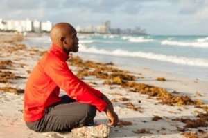 African American Sitting on Beach